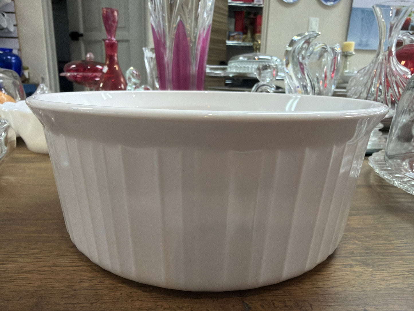 Pyrex CorningWare French White F-1-B 2.5 litros, es una cazuela redonda de cerámica vitrificada con diseño exterior acanalado, adecuada para uso directo del horno a la mesa.