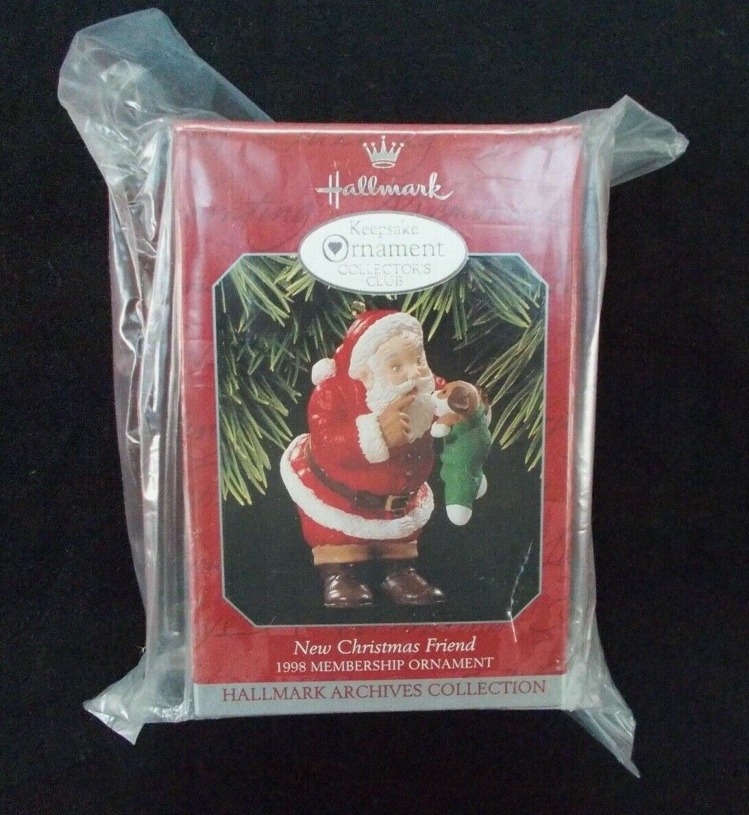 Adorno Hallmark Keepsake vintage que representa a Santa Claus con un cachorro nuevo.