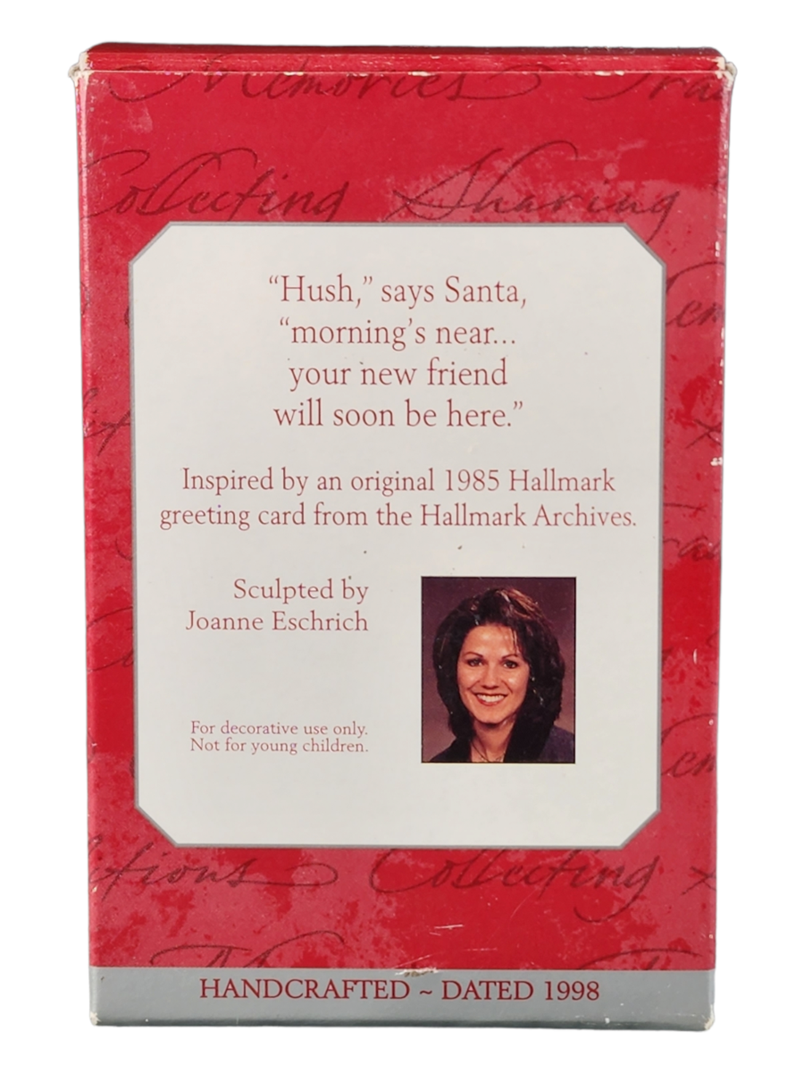 Adorno Hallmark Keepsake vintage que representa a Santa Claus con un cachorro nuevo.